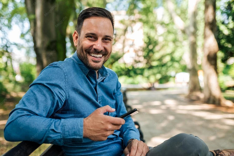 files/portrait-cheerful-handsome-young-adult-man-enjoying-nice-day-outside-using-phone_891700-1718.webp